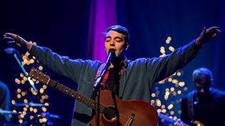 Student raises his hands in worship